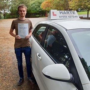 Young man holding pass certificate at Chesterfield test centre.