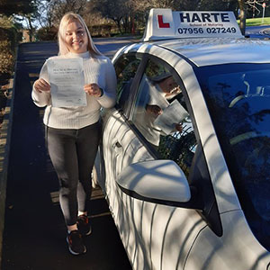 Happy young woman holding first time pass certificate in Chesterfield.