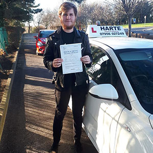 Happy young man holding first time pass certificate in Chesterfield